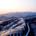 Aerial view of the solar power plant on the top of the mountain at sunset