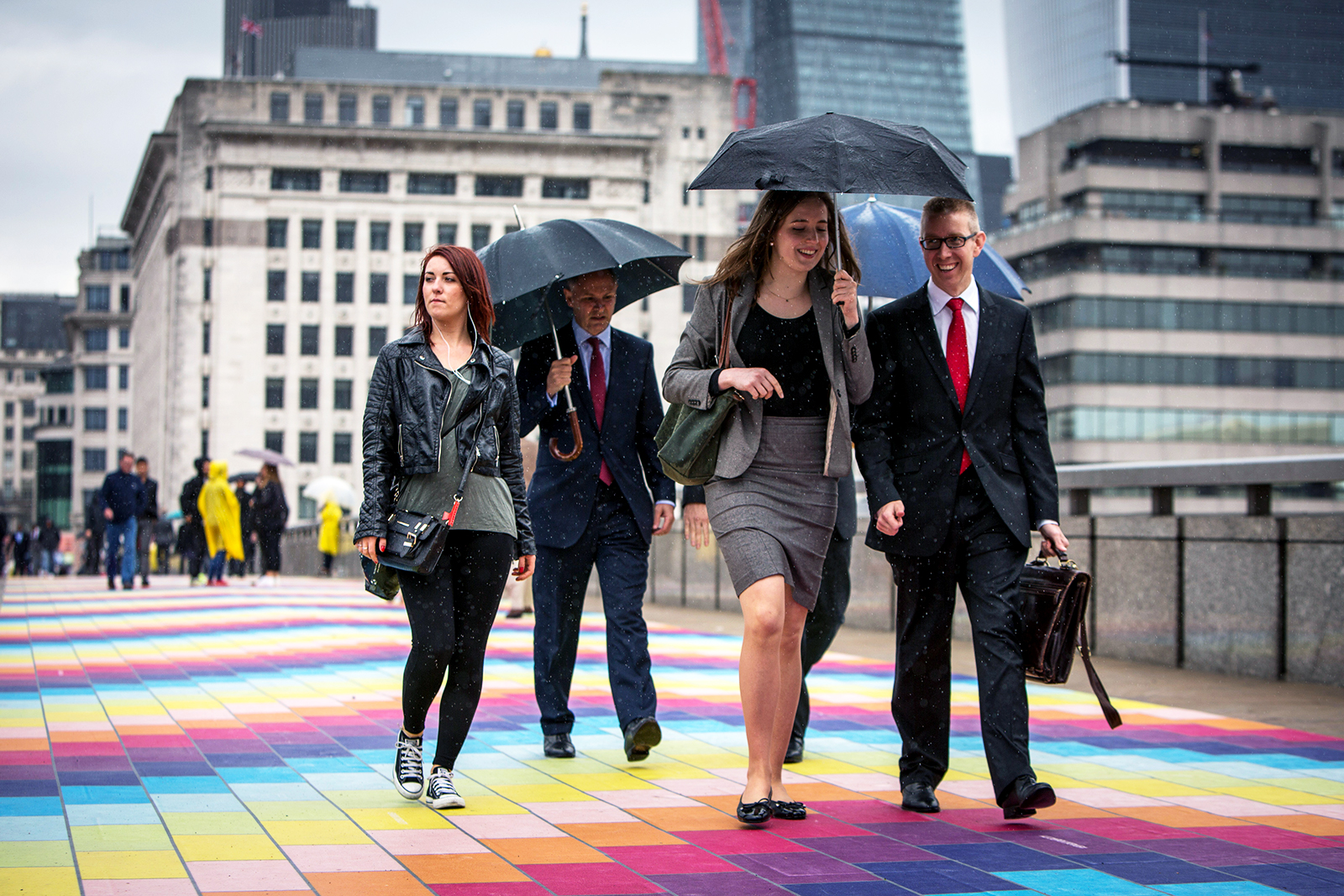 People travelling across London Bridge.