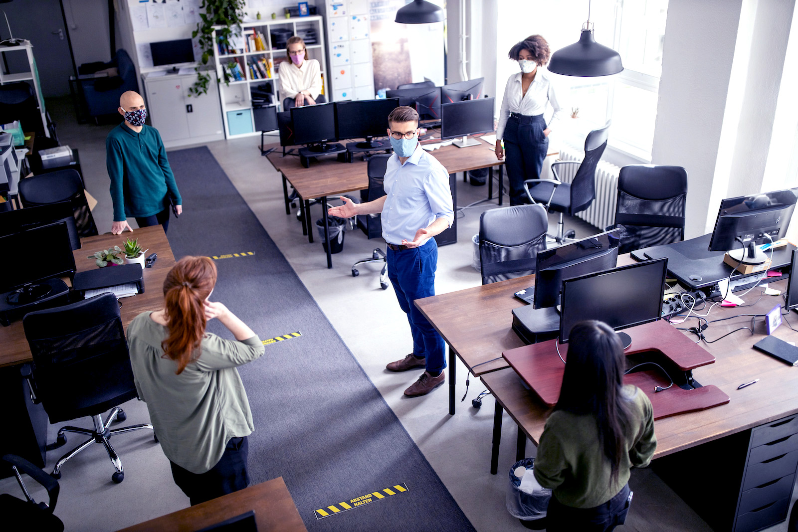 Staff meeting in office with social distancing