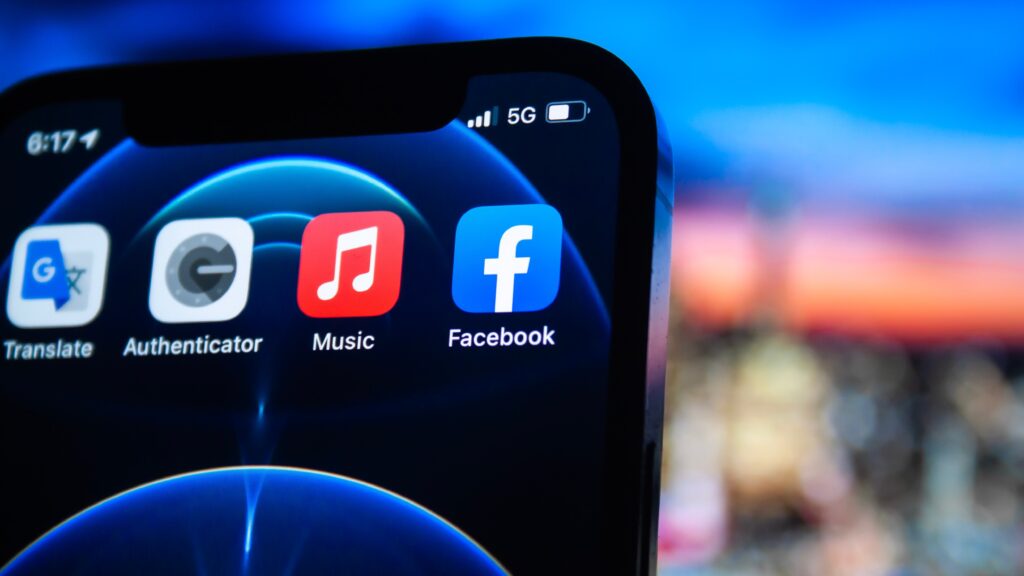 A photo of an iphone screen showing the facebook and music apps