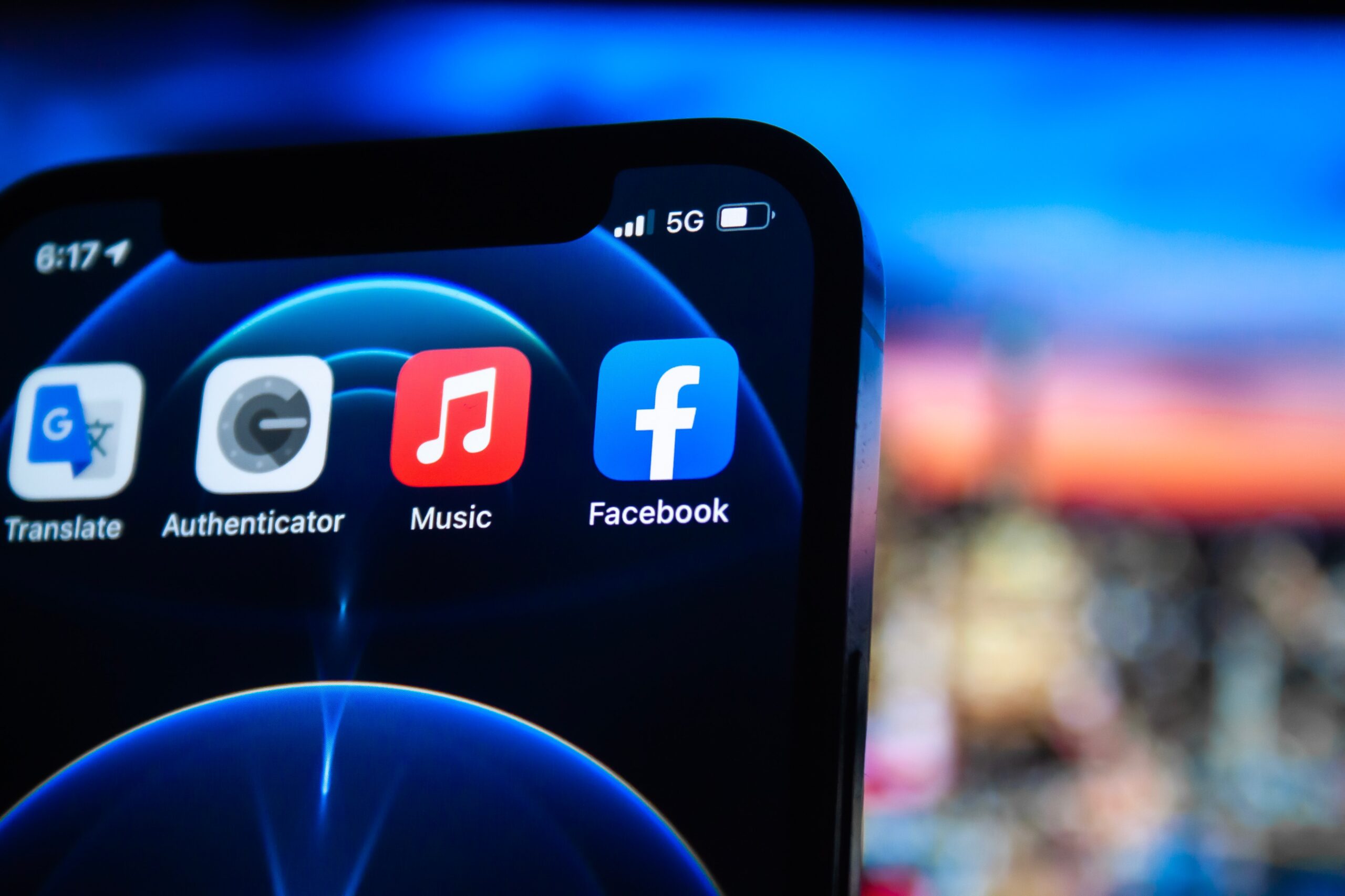 A photo of an iphone screen showing the facebook and music apps