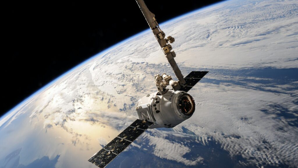 A view of a SpaceX satellite from behind orbiting the curve of the Earth