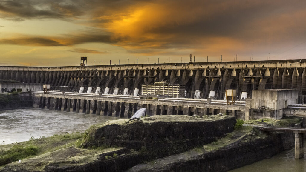 The Itaipu Dam, between Brazil and Paraguay, is shown at sunset.
