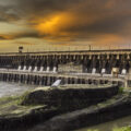 The Itaipu Dam, between Brazil and Paraguay, is shown at sunset.