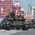 A line of tanks with soldiers drive through Red Square in Moscow, Russia.