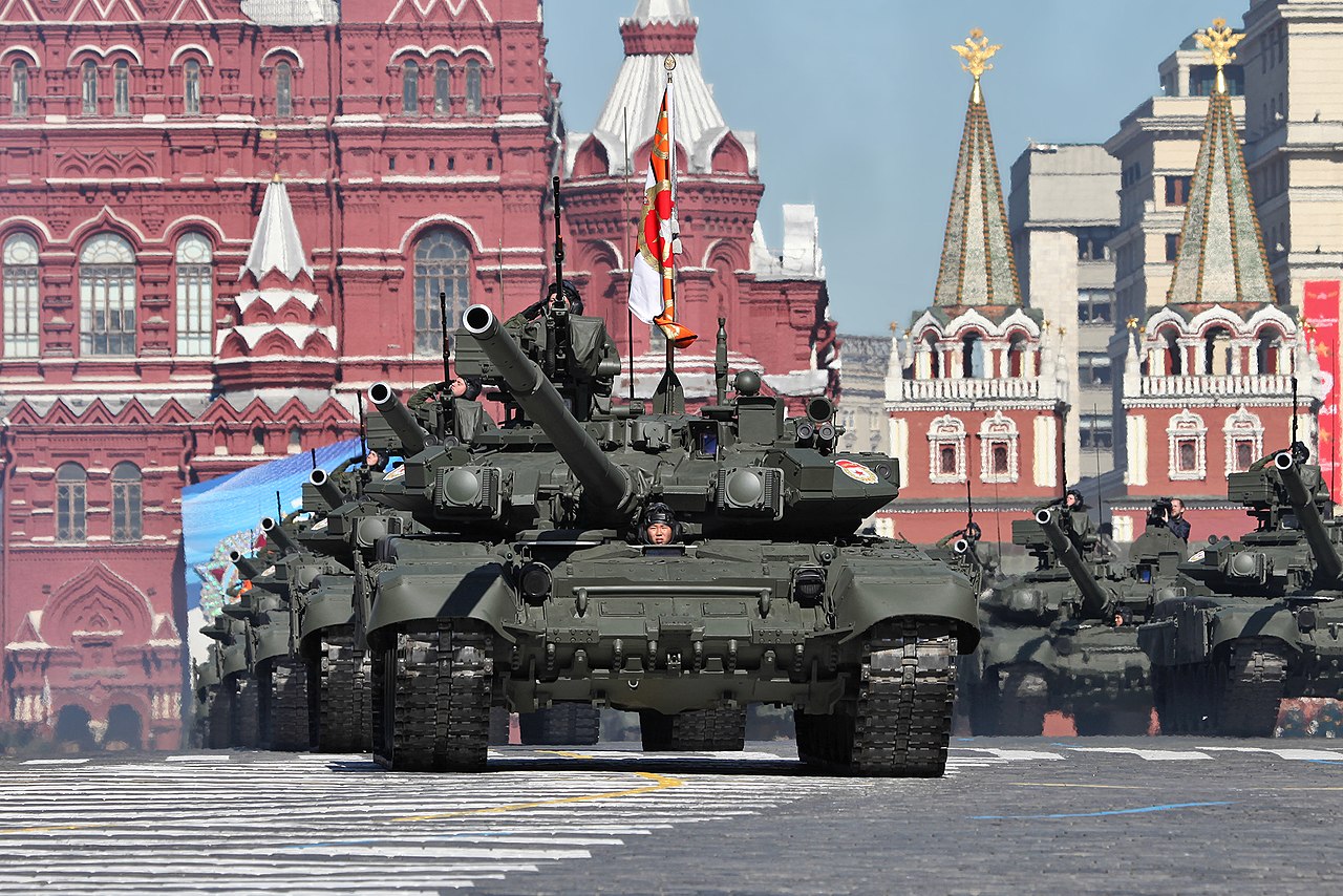 A line of tanks with soldiers drive through Red Square in Moscow, Russia.