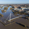 An aerial view of the flood water breaking the banks of the River Severn, showing water and submerged buildings.