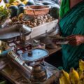 A shopper prepares to pay for produce at a market in India.