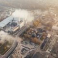 A birds eye view of a plant emitting smoke.