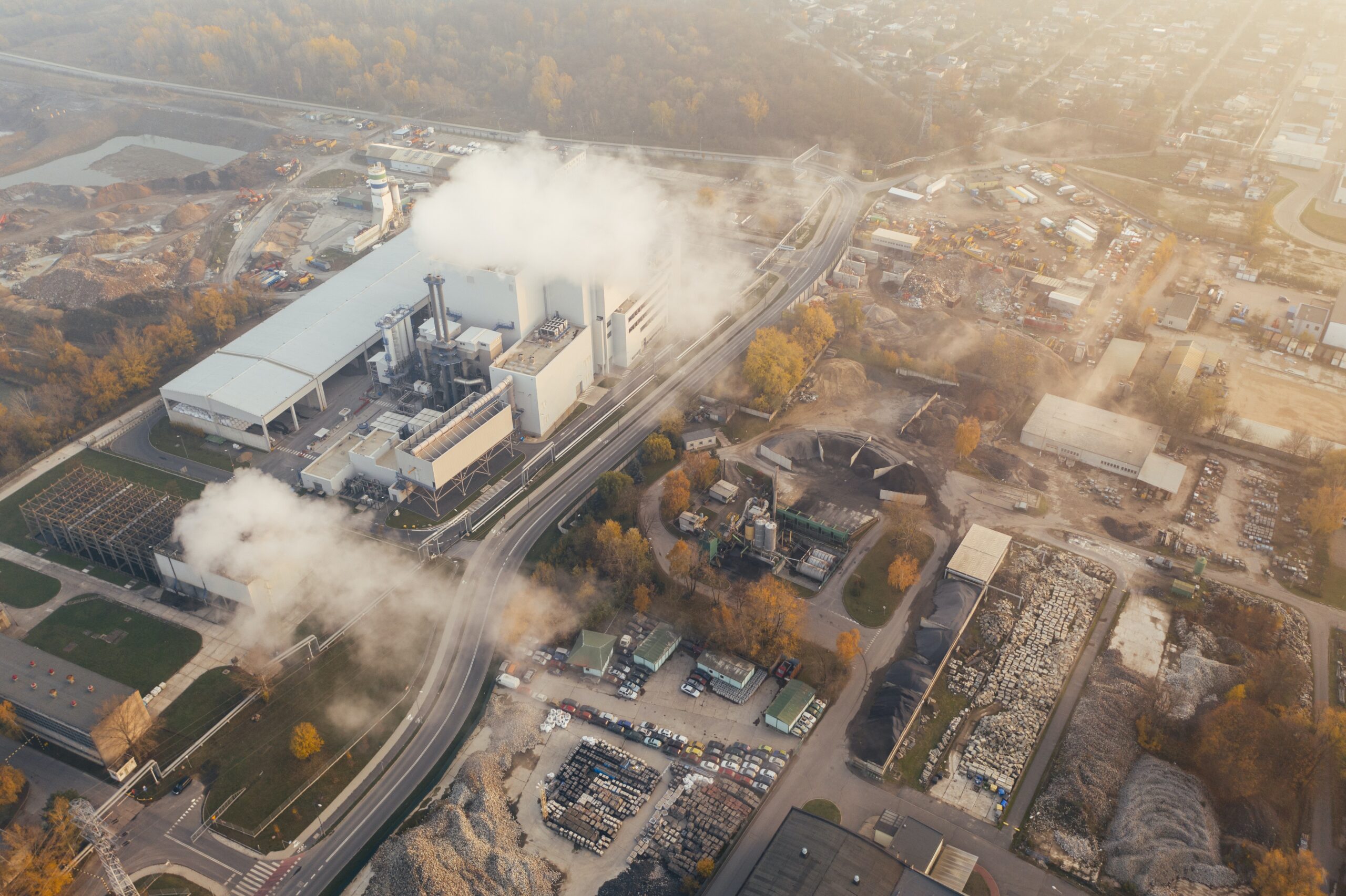 A birds eye view of a plant emitting smoke.