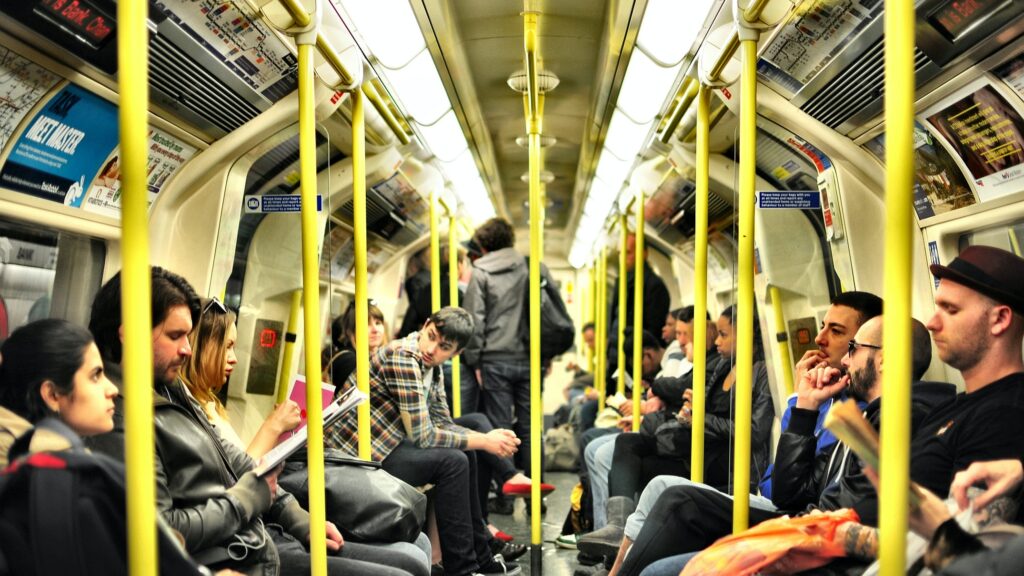 Commuters ride inside a tube car on the London Underground.