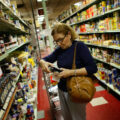 A shopper reads a product label at Lorenzo's Supermarket in North Miami.