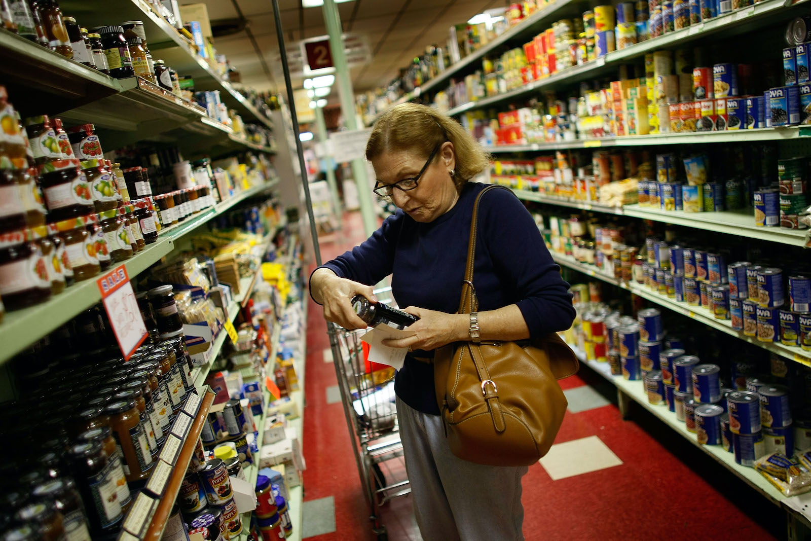 A shopper reads a product label at Lorenzo's Supermarket in North Miami.