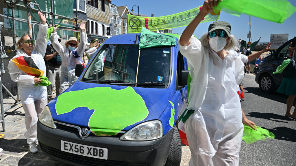 Demonstrators rally against greenwashing at a climate march in England.