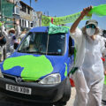 Demonstrators rally against greenwashing at a climate march in England.