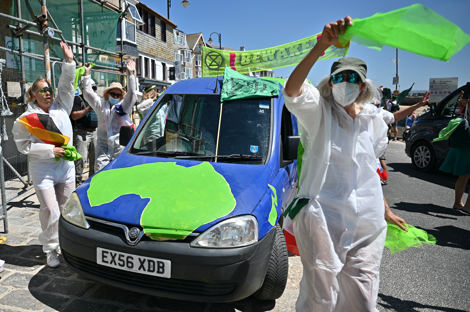 Demonstrators rally against greenwashing at a climate march in England.