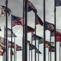 Flags of different nations on high flagpoles