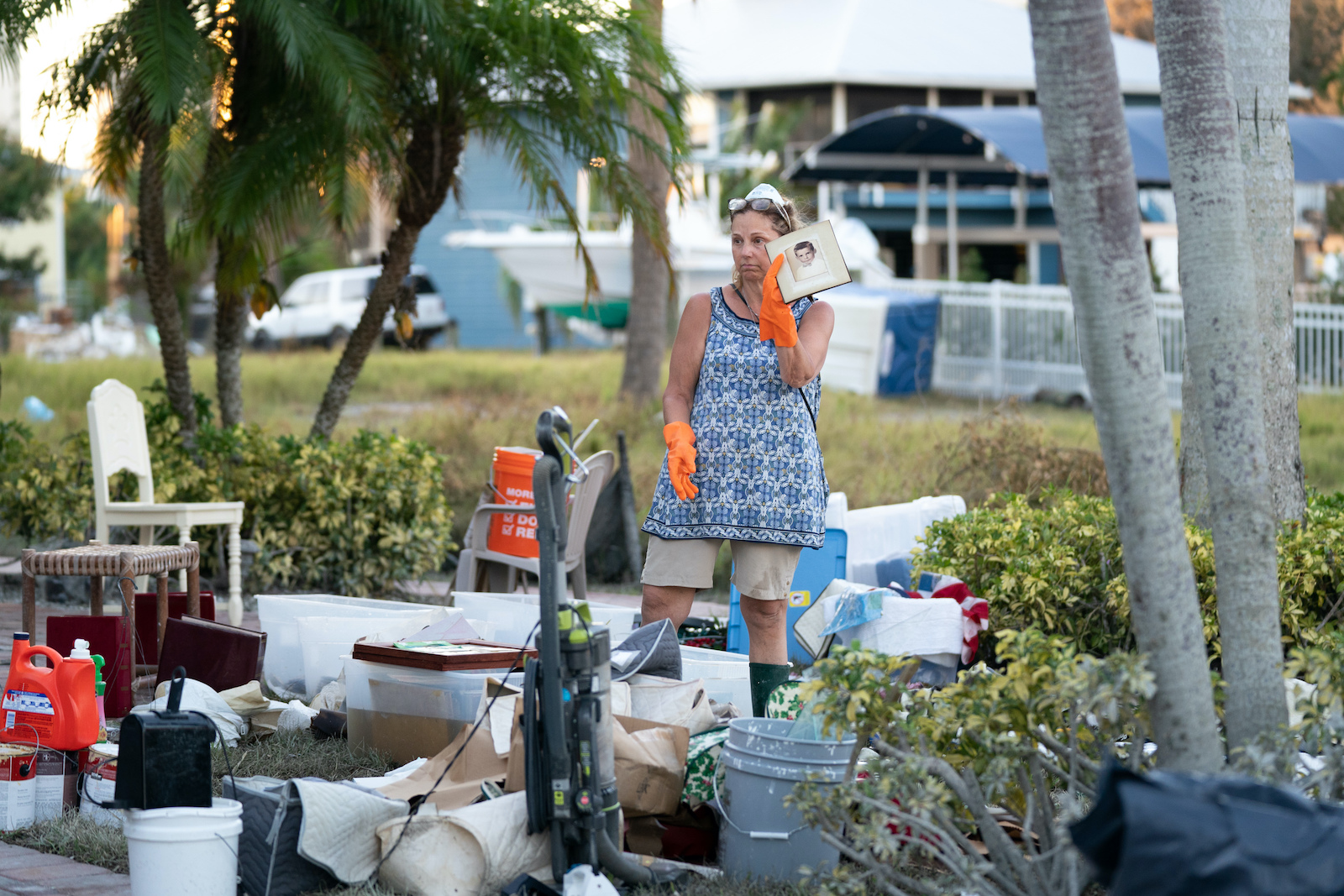 Jane Cihon sorts through family photos damaged by storm surge from Hurricane Ian on October 2, 2022