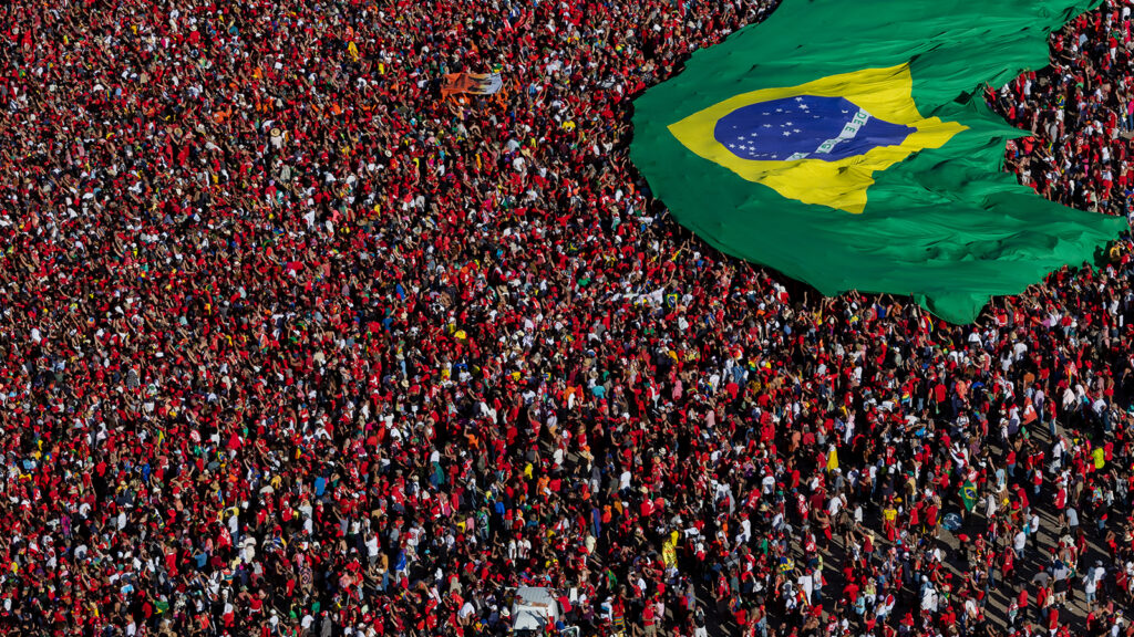 Supporters of President Luiz Inácio Lula Da Silva display a Brazilian flag during the presidential inauguration ceremony at Planalto Palace on January 1, 2023 in Brasilia Brazil