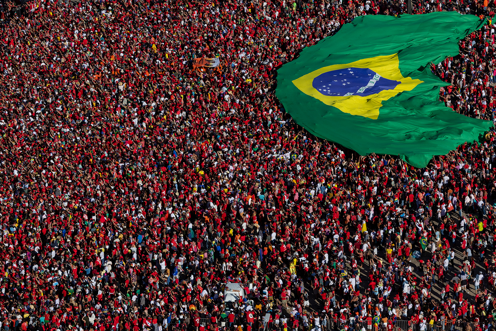 Supporters of President Luiz Inácio Lula Da Silva display a Brazilian flag during the presidential inauguration ceremony at Planalto Palace on January 1, 2023 in Brasilia Brazil