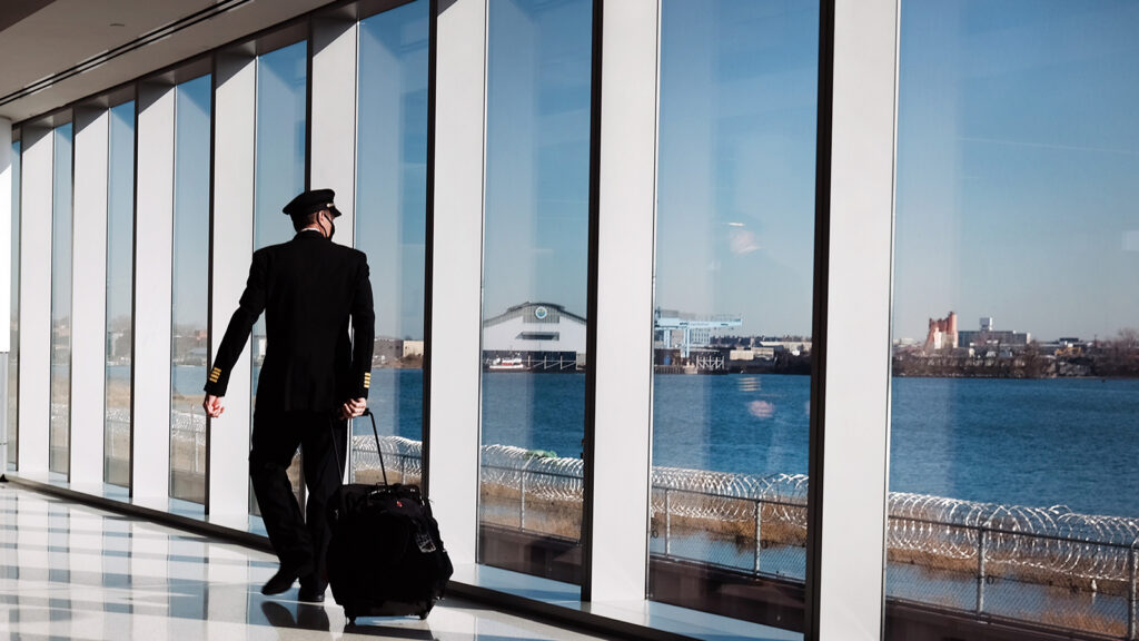 A pilot moves through New York's LaGuardia Airport